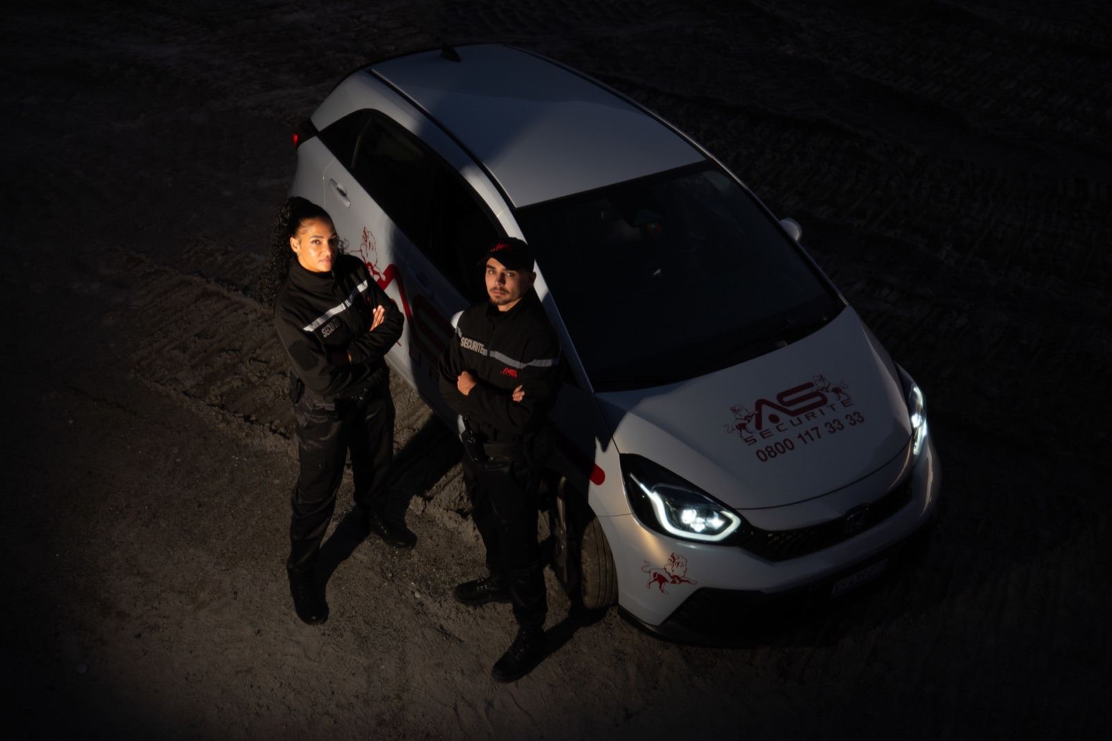 AS Sécurité agents in reflective vests in a parking lot