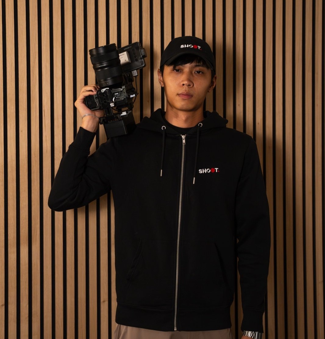 Mike, founder of Shoot, camera on shoulder